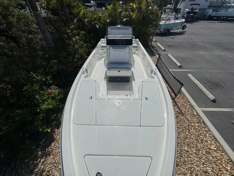 Slide: The Image of 2025 Skeeter SX 230 boat, top view, parked near greenery and pavement. - 21