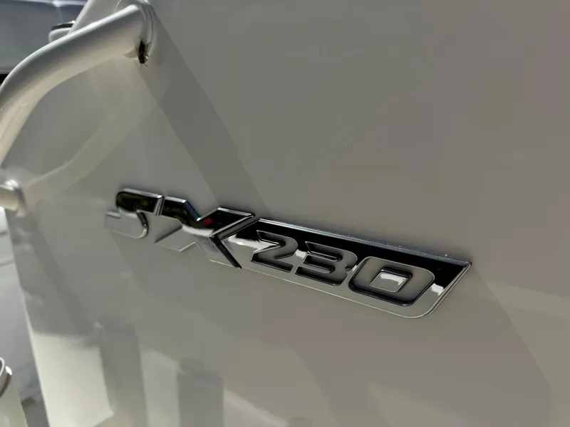 Slide: The Image of 2025 Skeeter SX 230 boat emblem on a sleek white surface. - 24