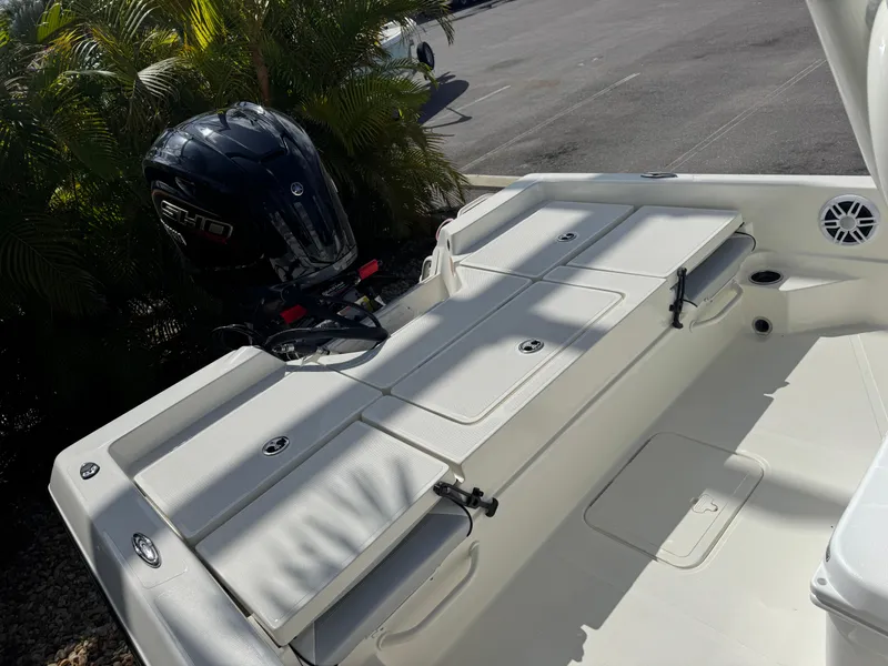 Slide: The Image of 2025 Skeeter SX 230 boat with outboard motor, white deck, and storage compartments. - 26
