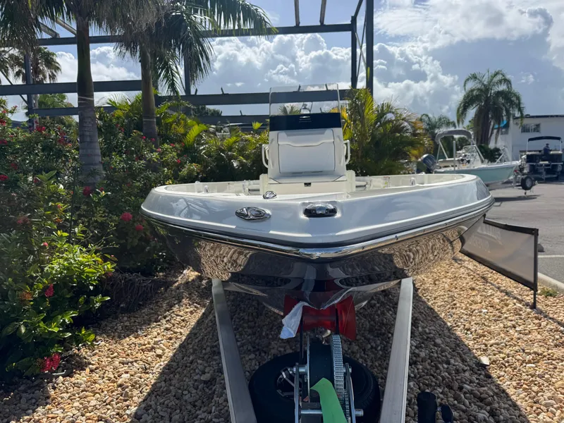 Slide: The Image of 2025 Skeeter SX 230 boat on trailer, surrounded by tropical plants and clear sky. - 4