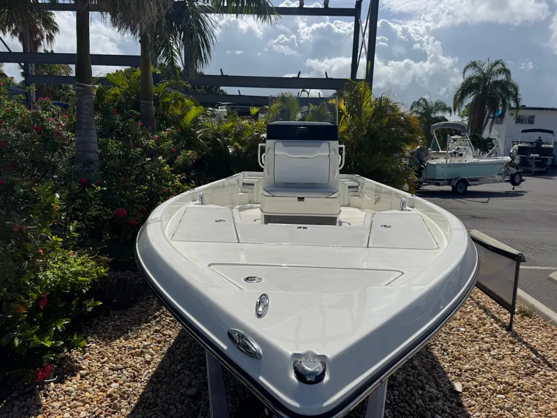 Slide: The Image of 2025 Skeeter SX 230 boat displayed outdoors, surrounded by tropical plants. - 5