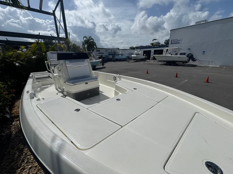 Slide: The Image of 2025 Skeeter SX 230 boat in a marina, showcasing sleek design and spacious deck. - 7