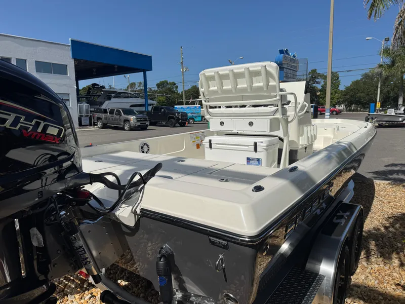 Slide: The Image of 2025 Skeeter SX 230 boat with Yamaha engine, parked outdoors on a sunny day. - 9