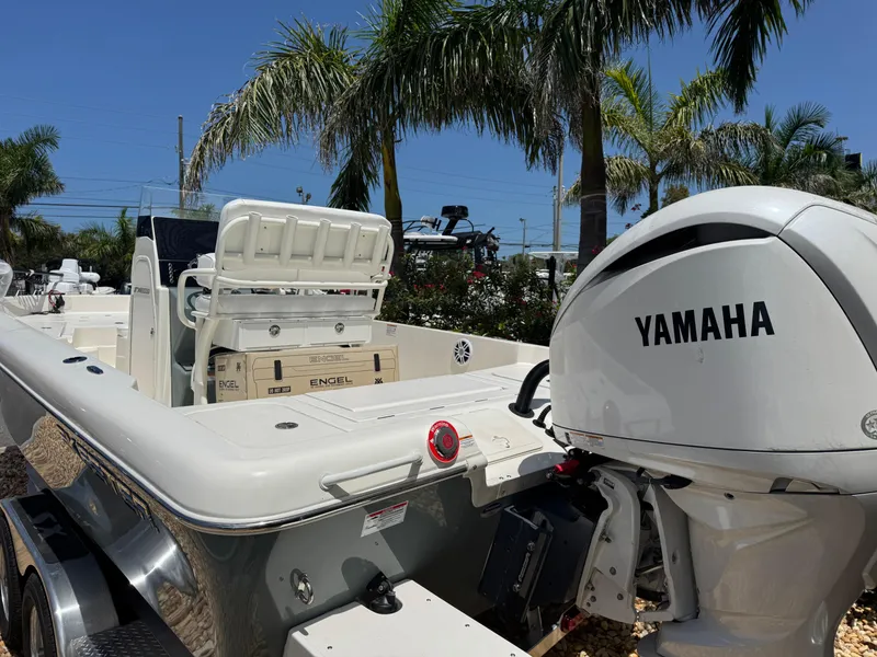 Slide: The Image of 2025 Skeeter SX 2350 boat with Yamaha engine, parked near palm trees. - 10