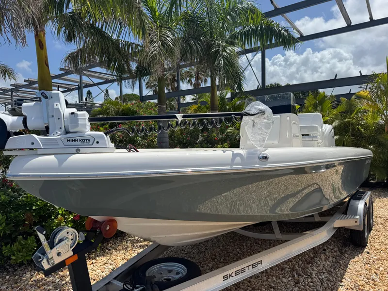 Slide: The Image of 2025 Skeeter SX 2350 boat on trailer, surrounded by tropical plants. - 3