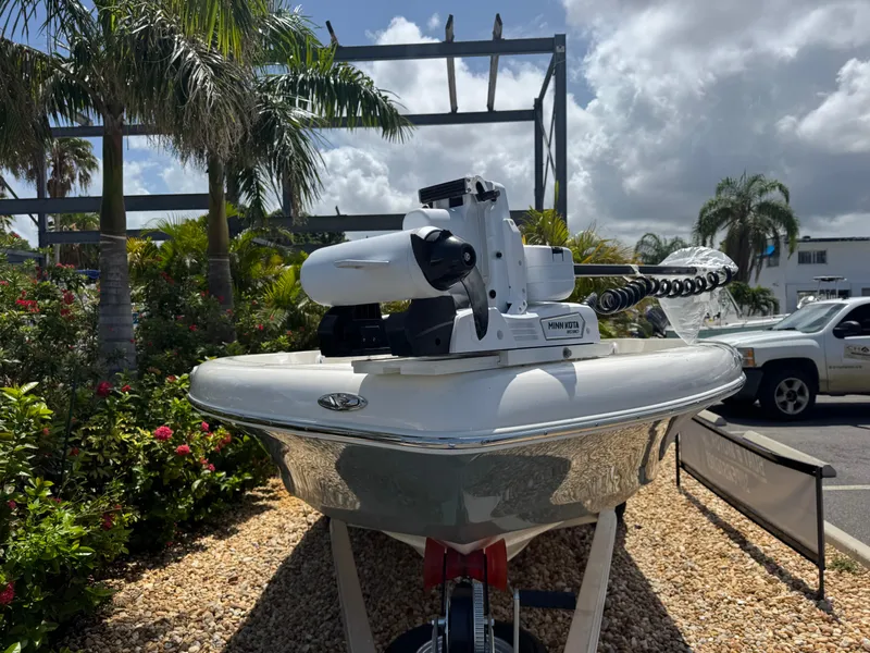 Slide: The Image of 2025 Skeeter SX 2350 boat displayed outdoors with tropical plants and clear sky. - 4