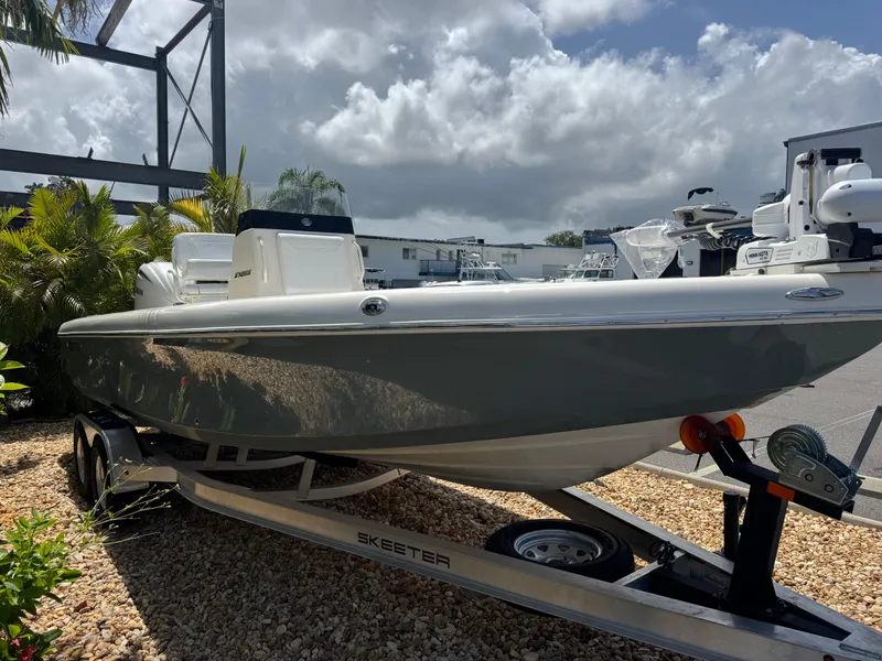 Slide: The Image of 2025 Skeeter SX 2350 boat on trailer, parked outdoors under cloudy sky. - 5