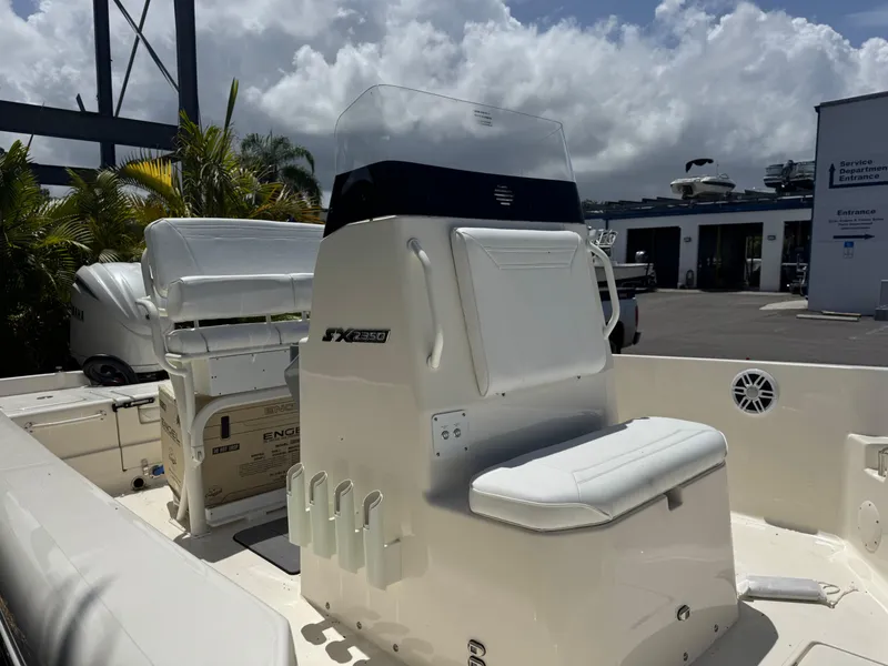 Slide: The Image of 2025 Skeeter SX 2350 boat interior with seating and console, under a cloudy sky. - 7