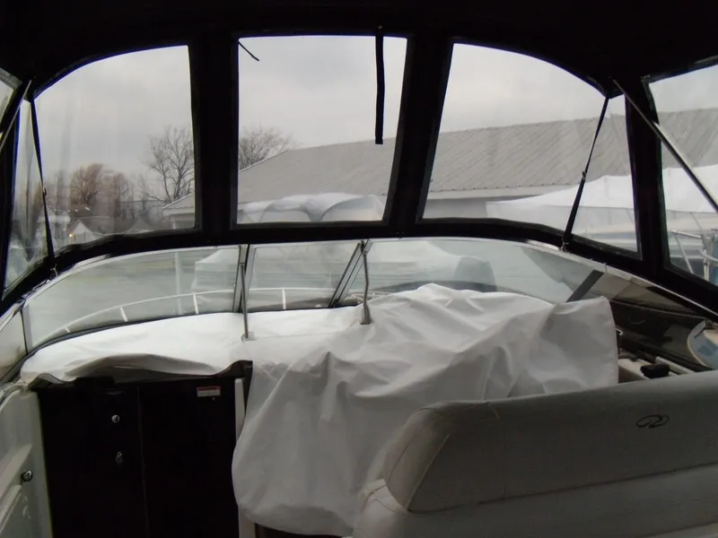 Slide: The Image of 2008 Regal Commodore 2665 boat interior with covered dashboard and seating. - 18