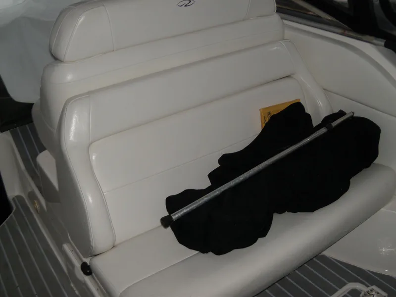 Slide: The Image of White seating on 2008 Regal Commodore 2665 boat with black cover and metal rod. - 4