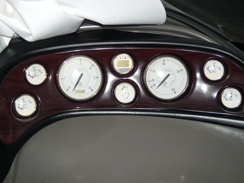 Slide: The Image of Dashboard of 2008 Regal Commodore 2665 boat with multiple gauges and wood finish. - 8