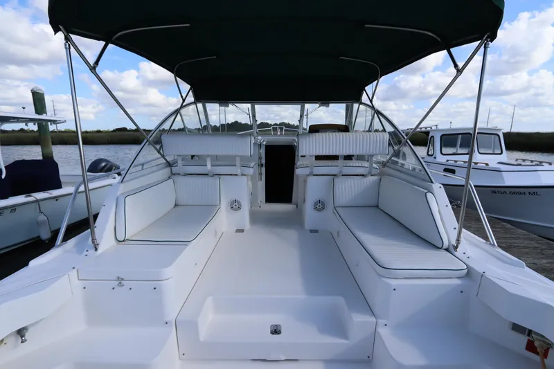 Slide: The Image of 2002 Mainship Pilot 34 boat interior with seating, canopy, and open deck view. - 15