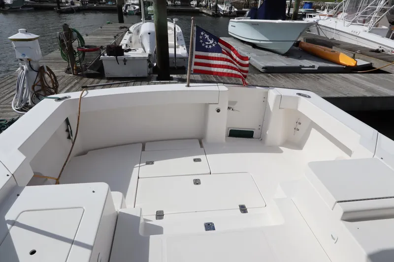 Slide: The Image of 2001 Mainship Pilot 34 boat deck with American flag at marina. - 19