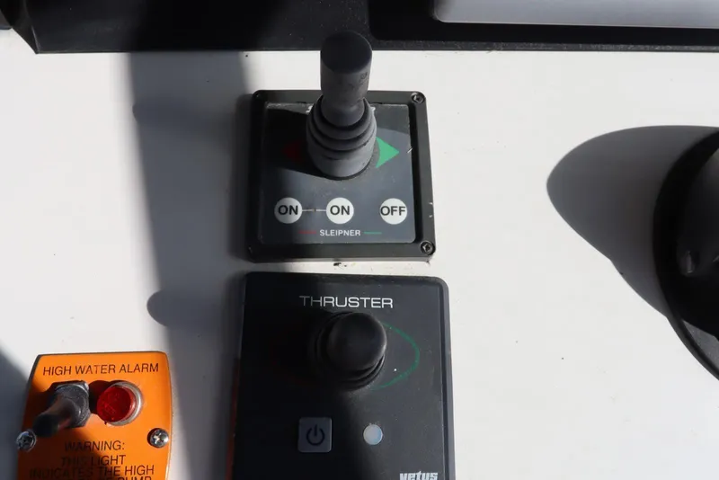 Slide: The Image of Control panel of a 2002 Mainship Pilot 34 with thruster and high water alarm. - 25