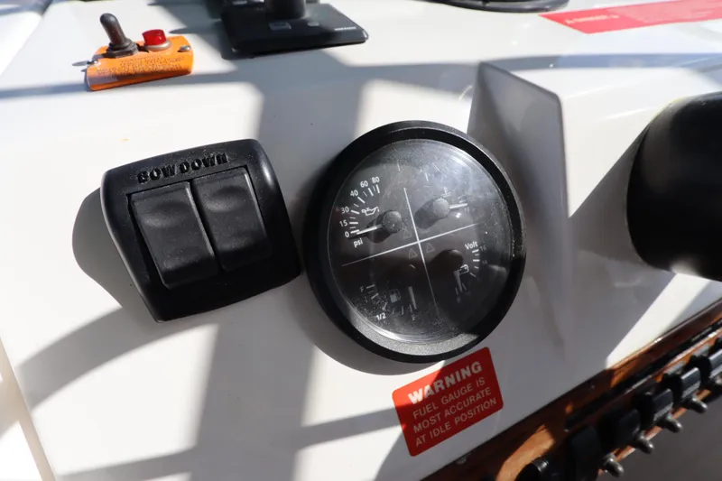 Slide: The Image of Control panel of a 2002 Mainship Pilot 34 boat with gauges and warning label. - 29