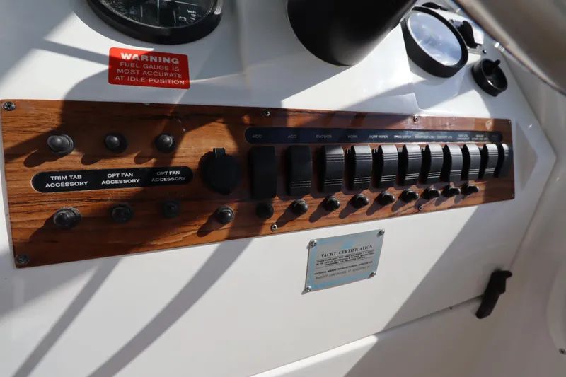 Slide: The Image of Control panel of 2002 Mainship Pilot 34 boat with switches and warning label. - 30