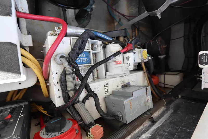 Slide: The Image of Engine compartment of a 2002 Mainship Pilot 34, showcasing wiring and mechanical components. - 39