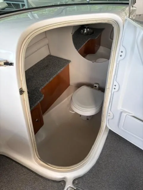 Slide: The Image of 2007 Chaparral Sunesta 274 boat interior with compact bathroom and toilet. - 10