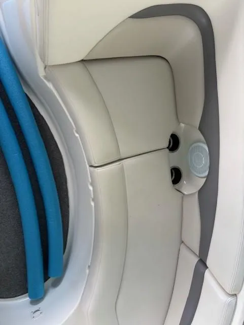 Slide: The Image of 2007 Chaparral Sunesta 274 boat interior with white and gray seating, blue pool noodles. - 12