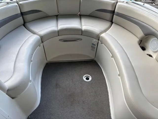 Slide: The Image of 2007 Chaparral Sunesta 274 boat interior with curved seating and gray upholstery. - 14