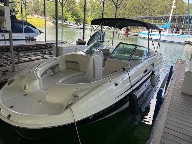 Slide: The Image of 2007 Chaparral Sunesta 274 boat docked in a marina, featuring a sleek design and canopy. - 3