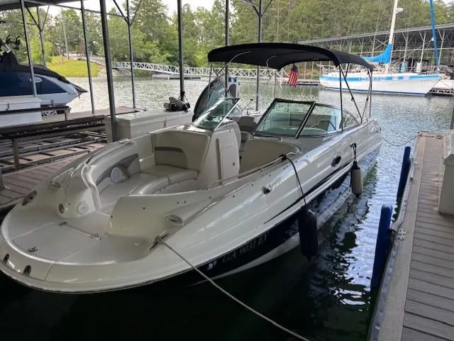 Slide: The Image of 2007 Chaparral Sunesta 274 boat docked in a marina with canopy and seating. - 6
