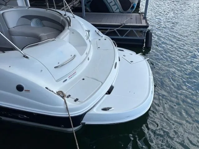 Slide: The Image of 2007 Chaparral Sunesta 274 boat docked, featuring spacious seating and swim platform. - 7
