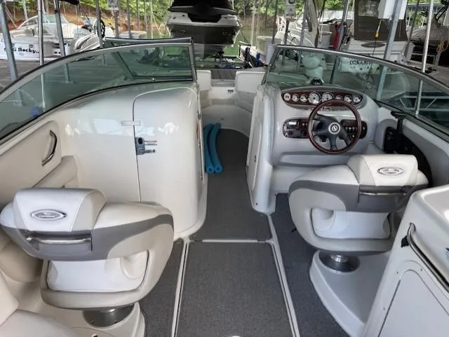 Slide: The Image of 2007 Chaparral Sunesta 274 boat interior with seating and dashboard, docked in marina. - 9