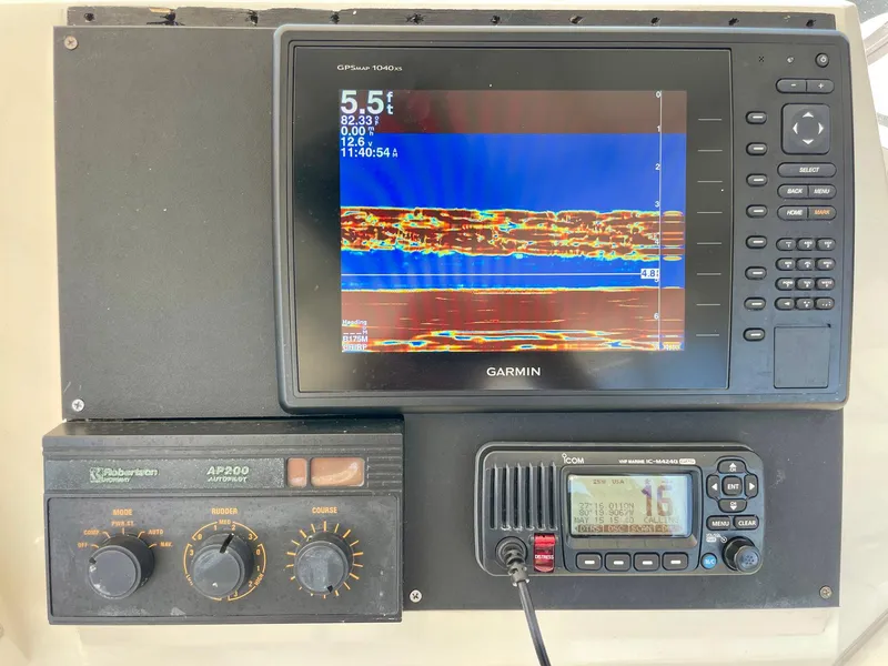 Slide: The Image of Garmin marine electronics on 1988 Bertram 43 Convertible boat dashboard. - 17