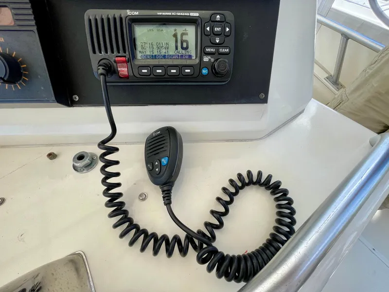 Slide: The Image of VHF radio on 1988 Bertram 43 Convertible boat dashboard with coiled microphone. - 18