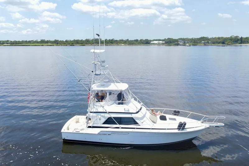 Slide: The Image of 1988 Bertram 43 Convertible yacht on calm water under a clear sky. - 2