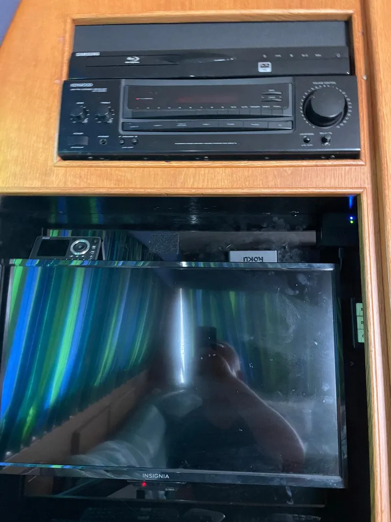 Slide: The Image of 1988 Bertram 43 Convertible interior with audio system and Insignia TV. - 22