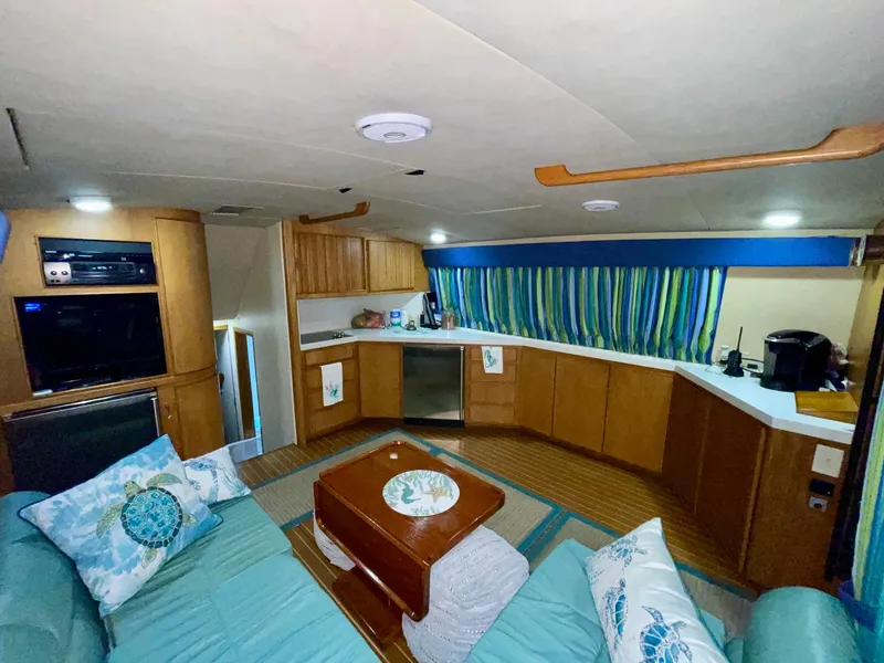 Slide: The Image of Interior of 1988 Bertram 43 Convertible yacht with cozy seating and modern kitchen amenities. - 25