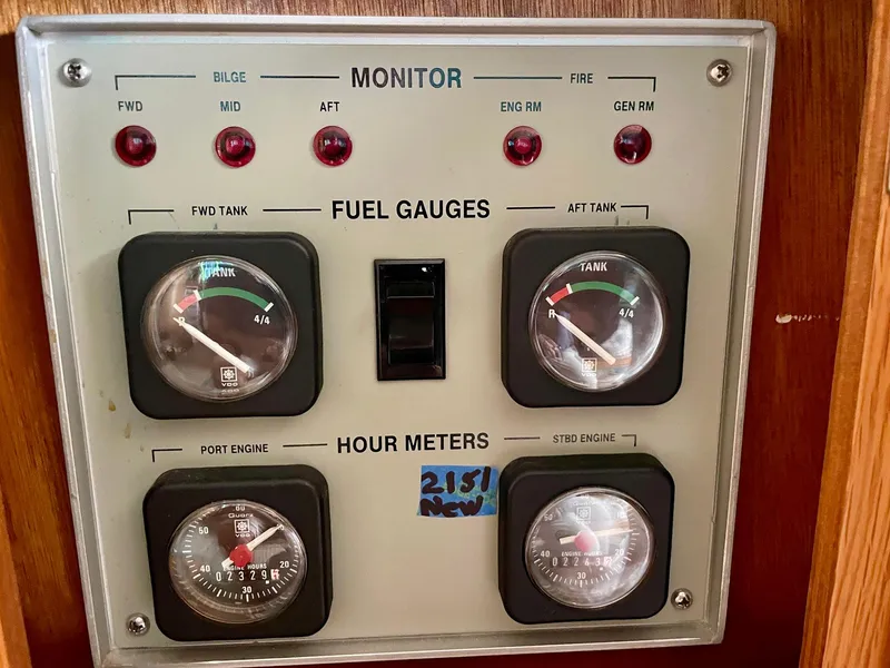 Slide: The Image of 1988 Bertram 43 Convertible fuel and hour meter panel with gauges and indicators. - 28
