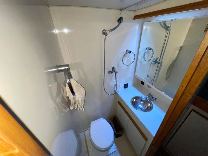 Slide: The Image of Bathroom in 1988 Bertram 43 Convertible yacht with sink, toilet, and shower. - 30
