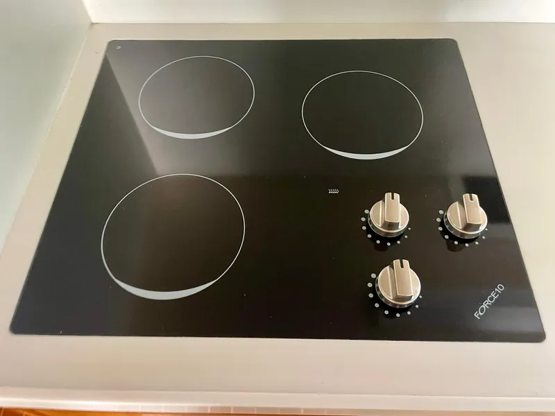 Slide: The Image of Four-burner electric stove with control knobs on a Bertram 43 Convertible, 1988 model. - 7