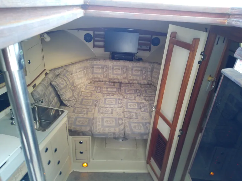 Slide: The Image of Interior cabin of 1996 Albin 31 Tournament Express with cozy seating and small sink. - 29