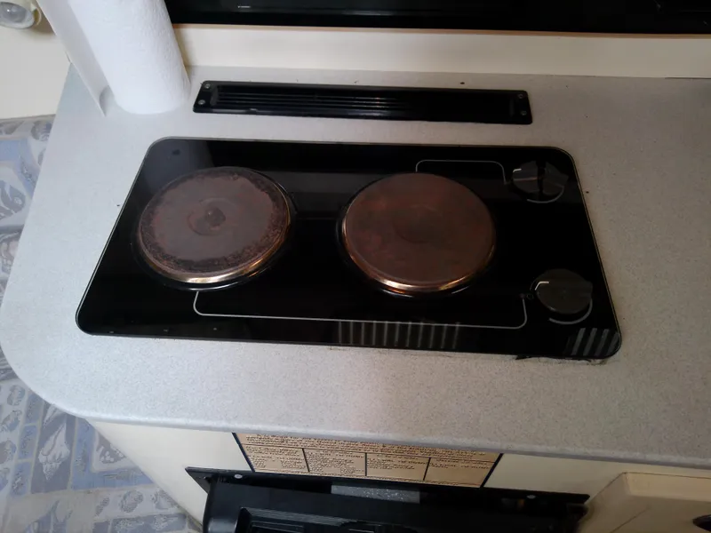 Slide: The Image of Stovetop in 1996 Albin 31 Tournament Express boat kitchen area. - 38