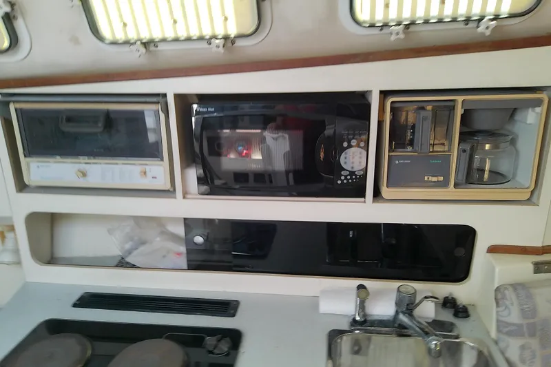 Slide: The Image of 1996 Albin 31 Tournament Express galley with microwave, toaster oven, and coffee maker. - 82