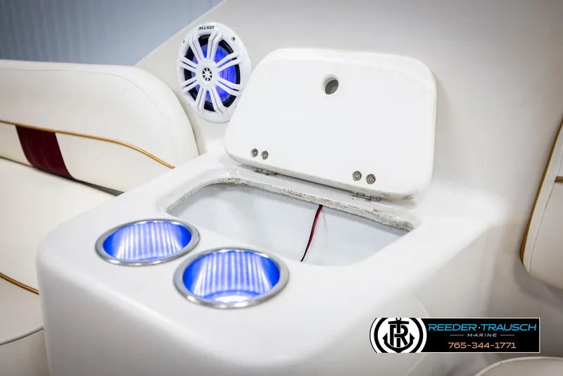 Slide: The Image of 1999 Crownline 242 CR boat interior with cup holders and speaker. - 21