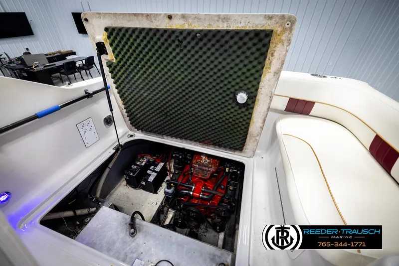Slide: The Image of Open engine compartment of 1999 Crownline 242 CR boat, showcasing interior components. - 25