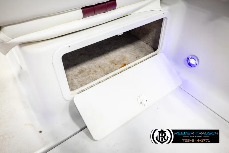 Slide: The Image of Open storage compartment on 1999 Crownline 242 CR boat with blue LED light. - 29