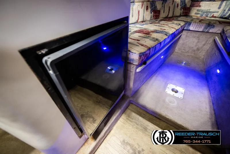 Slide: The Image of 1999 Crownline 242 CR cabin interior with blue LED lighting and patterned seating. - 41