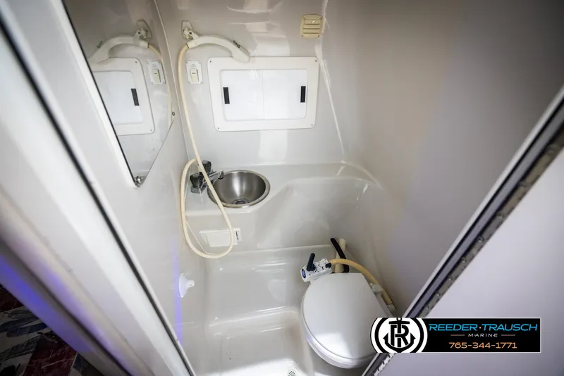 Slide: The Image of 1999 Crownline 242 CR boat bathroom with sink, shower, and toilet. - 43