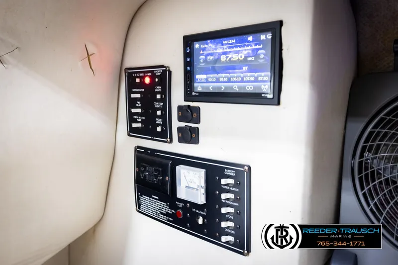 Slide: The Image of Control panel of a 1999 Crownline 242 CR boat with radio and switches. - 44