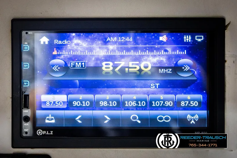 Slide: The Image of Touchscreen radio display showing FM frequency 87.50 MHz on a 1999 Crownline 242 CR boat. - 45