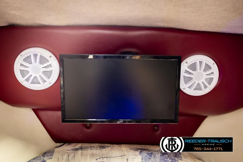 Slide: The Image of Interior of 1999 Crownline 242 CR boat with TV and speakers. - 46