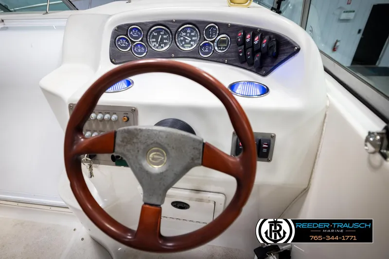 Slide: The Image of Steering wheel and dashboard of 1999 Crownline 242 CR boat. - 48