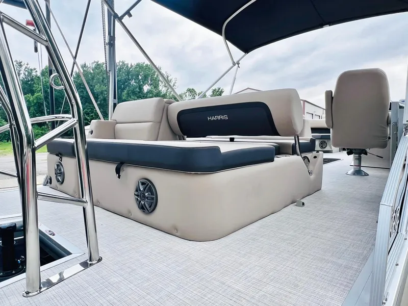 Slide: The Image of 2025 Harris Cruiser 230 boat interior with beige seating and canopy. - 12