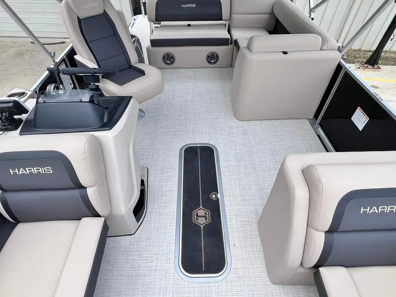 Slide: The Image of Interior of 2025 Harris Cruiser 230 boat with beige and gray seating. - 19